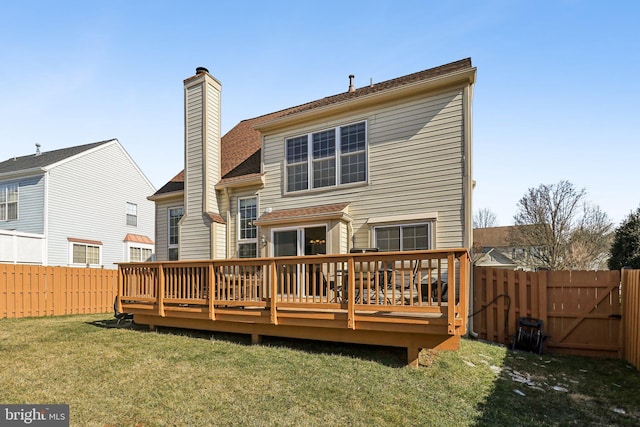 back of house with a yard and a wooden deck