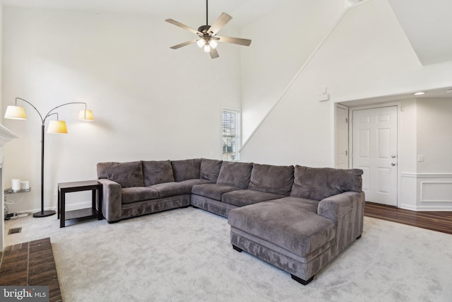 living room with ceiling fan and high vaulted ceiling