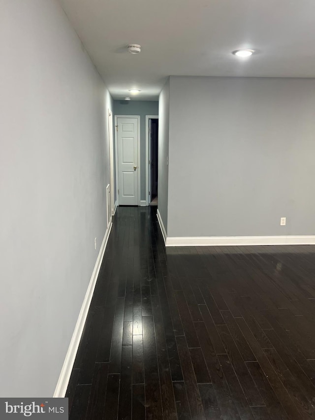 hallway with dark hardwood / wood-style floors