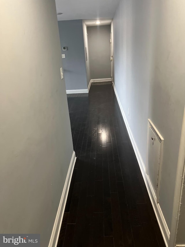 corridor featuring dark hardwood / wood-style flooring