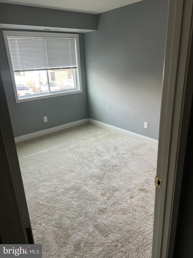 spare room with light carpet