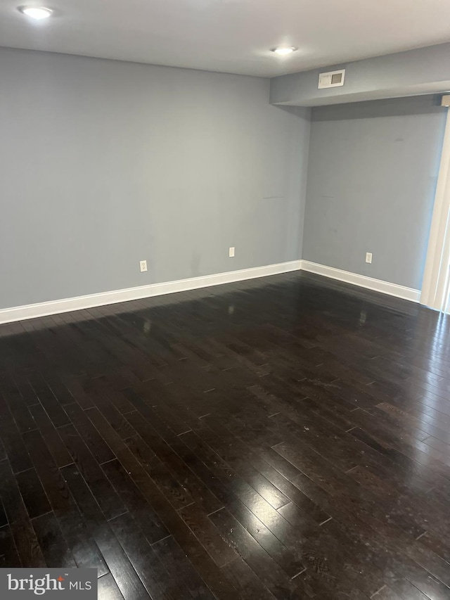 unfurnished room featuring dark hardwood / wood-style floors