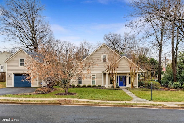 view of front of home featuring a garage, driveway, and a front lawn