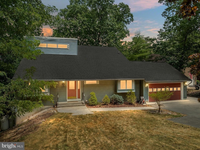 view of front of home featuring a garage and a lawn