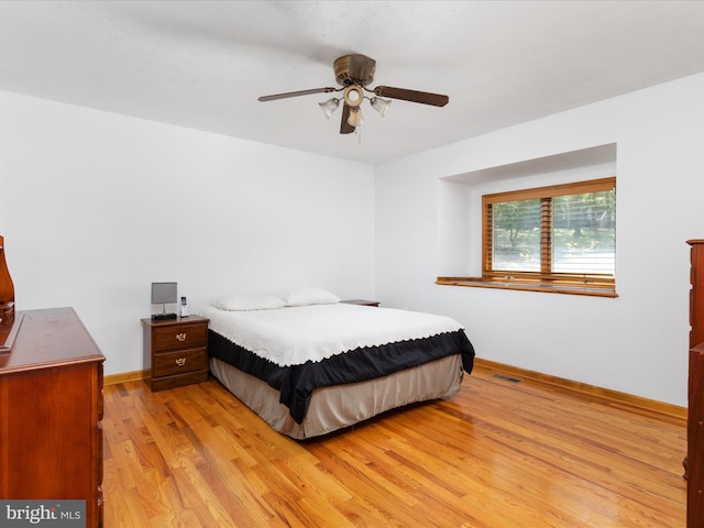 bedroom with light hardwood / wood-style floors and ceiling fan