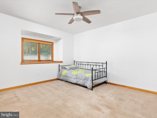 bedroom with ceiling fan and light colored carpet