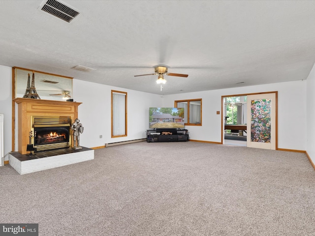 unfurnished living room featuring ceiling fan, a textured ceiling, and carpet flooring