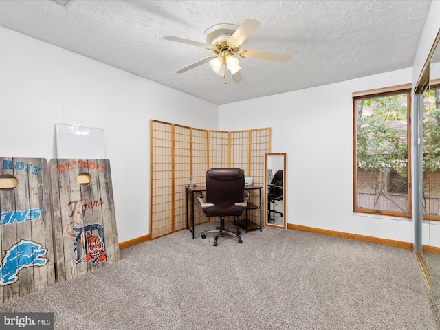 carpeted office with ceiling fan and a textured ceiling