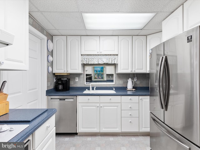 kitchen featuring white cabinetry, stainless steel appliances, sink, and backsplash