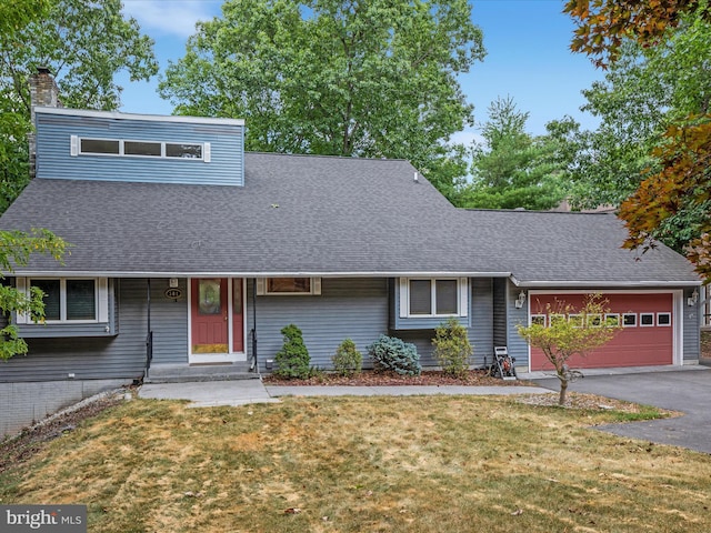 view of front of house with a garage and a front yard