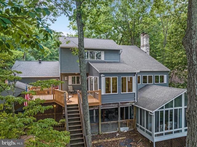 back of house featuring a deck and a sunroom