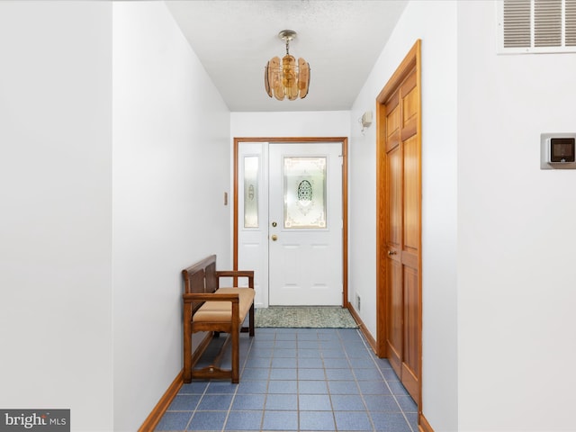 doorway with an inviting chandelier