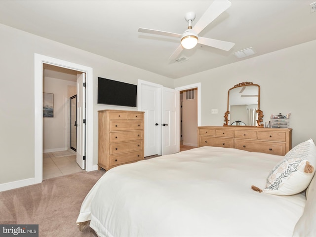 carpeted bedroom with ceiling fan and connected bathroom