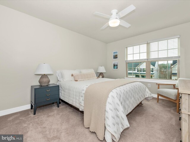 bedroom featuring light carpet and ceiling fan