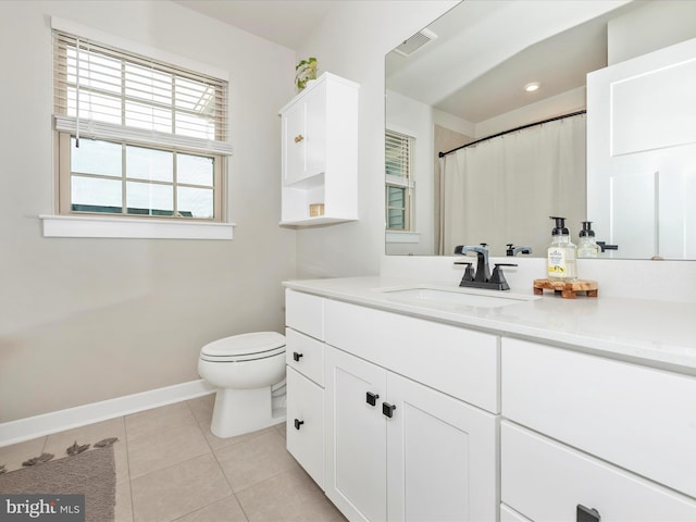 bathroom featuring vanity, tile patterned floors, and toilet