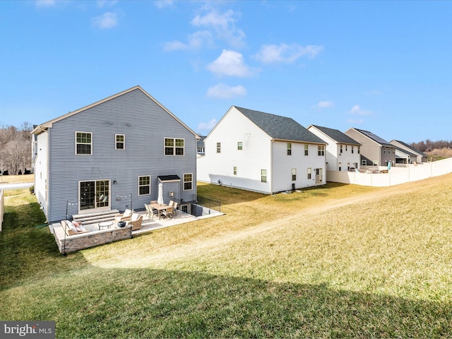 rear view of house with a yard and a patio area