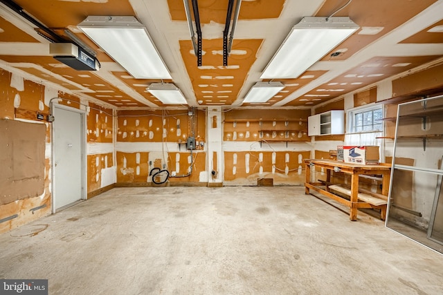 garage with a garage door opener and a workshop area