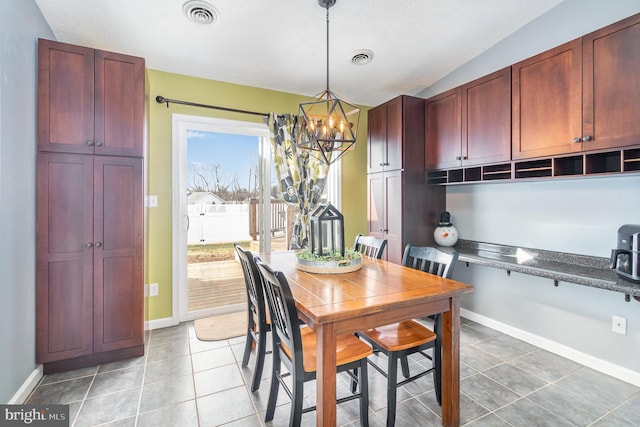 tiled dining area featuring a notable chandelier