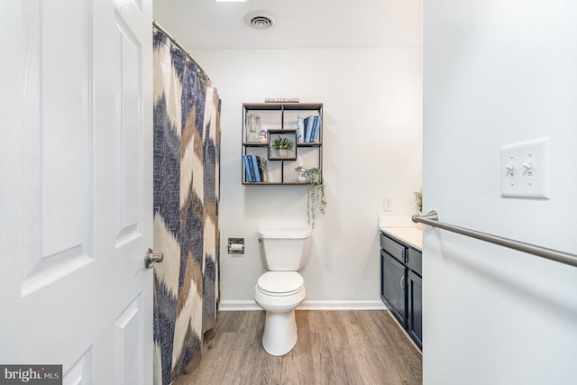 bathroom with vanity, wood-type flooring, and toilet