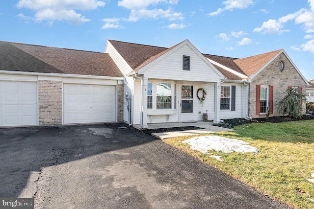 ranch-style home with a garage and a front yard