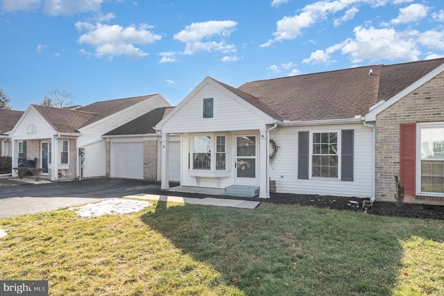 single story home featuring a garage and a front yard