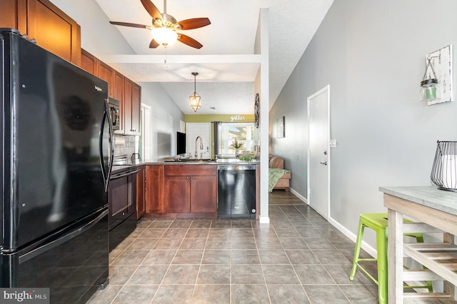 kitchen with sink, ceiling fan, tile patterned flooring, black appliances, and vaulted ceiling