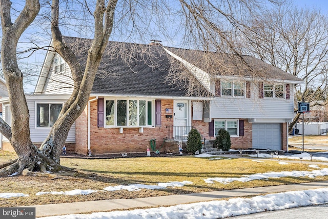 view of front of home featuring a garage and a lawn