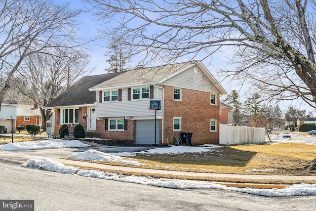 view of front of house featuring a garage and cooling unit