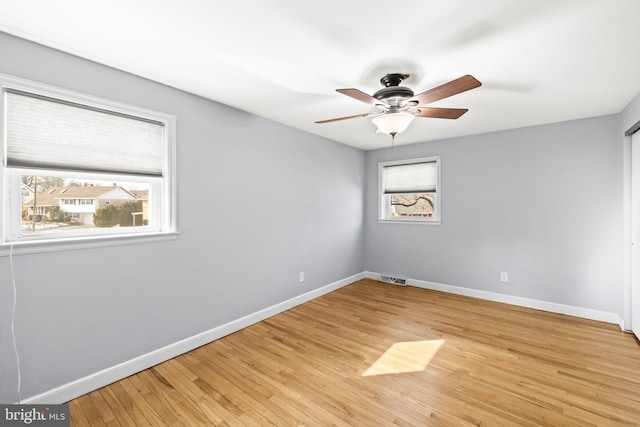 spare room featuring light hardwood / wood-style flooring and ceiling fan