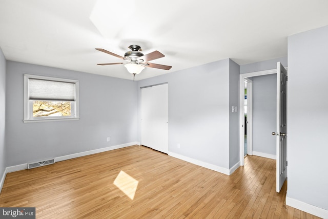 empty room featuring ceiling fan and light wood-type flooring