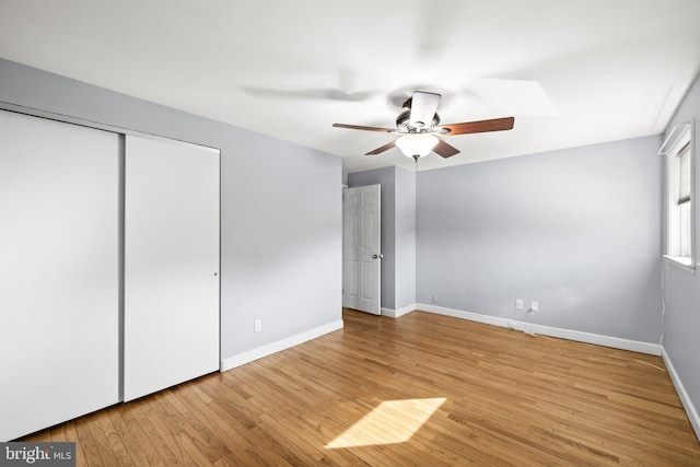 unfurnished bedroom with ceiling fan, light hardwood / wood-style floors, and a closet