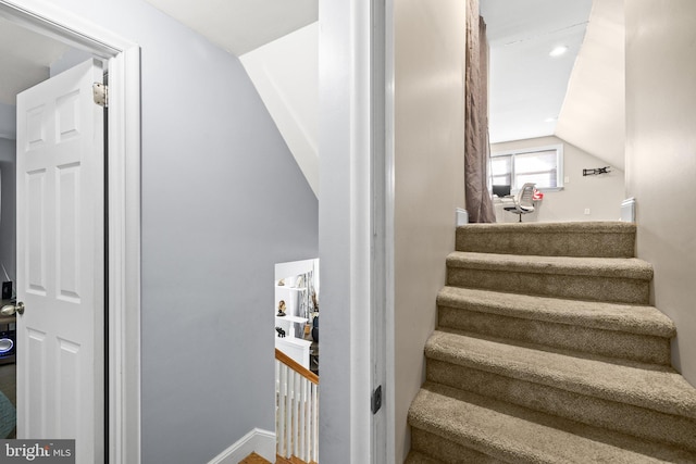 stairs with vaulted ceiling