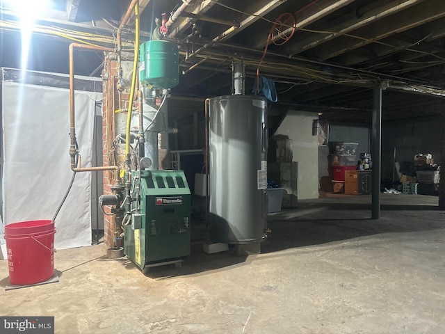 utility room featuring water heater and a heating unit