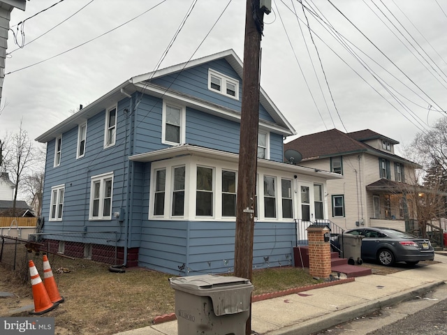 view of side of property featuring fence