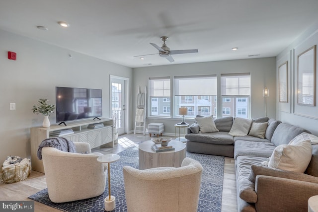 living room featuring ceiling fan and light wood-type flooring