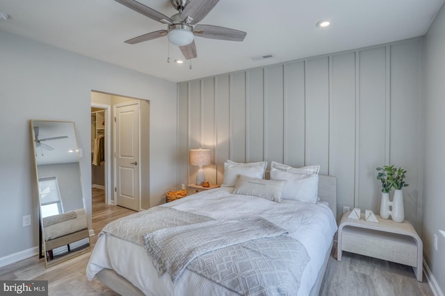 bedroom with light hardwood / wood-style floors and ceiling fan