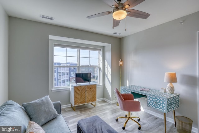 office with ceiling fan and light hardwood / wood-style floors