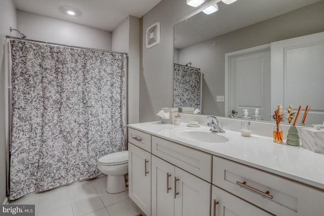 bathroom featuring tile patterned floors, vanity, and toilet