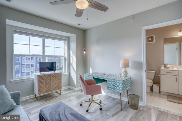 office space featuring ceiling fan and light wood-type flooring