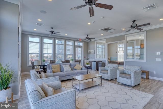 living room featuring ornamental molding and light hardwood / wood-style flooring