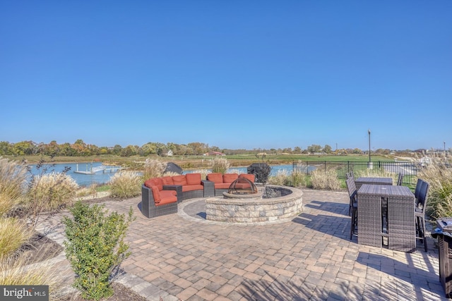 view of patio featuring a water view and an outdoor fire pit