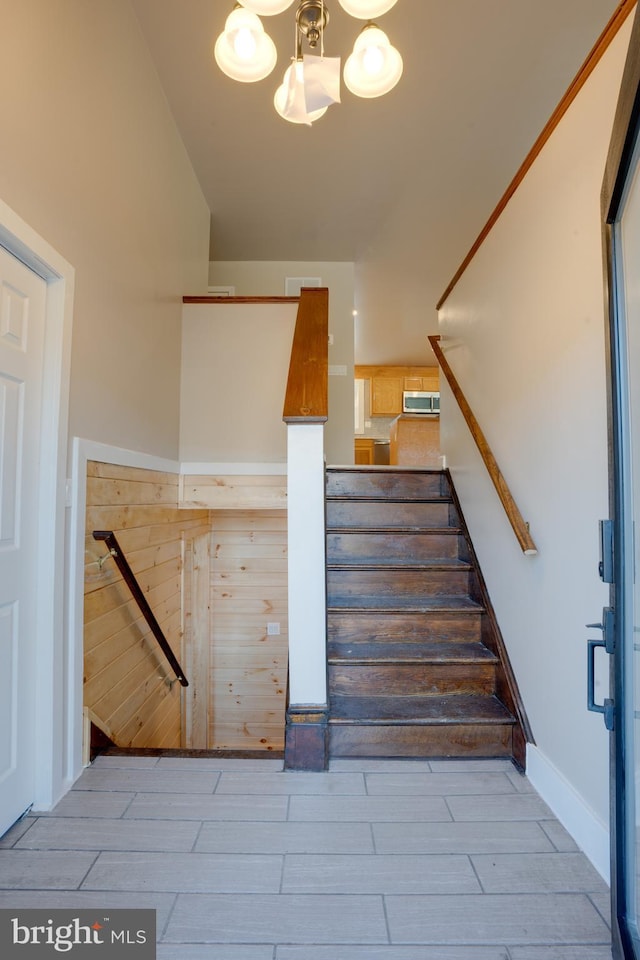 stairs featuring an inviting chandelier