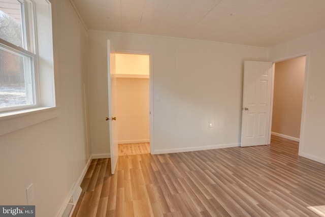 interior space featuring crown molding and light wood-type flooring