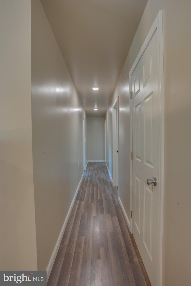 hallway with dark hardwood / wood-style floors