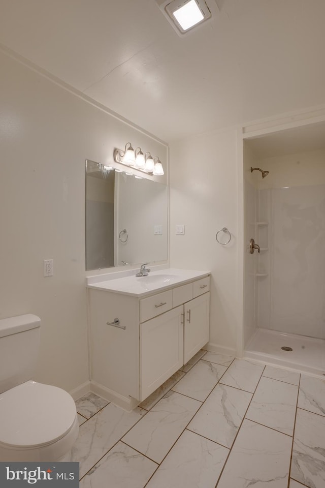 bathroom with toilet, vanity, and walk in shower