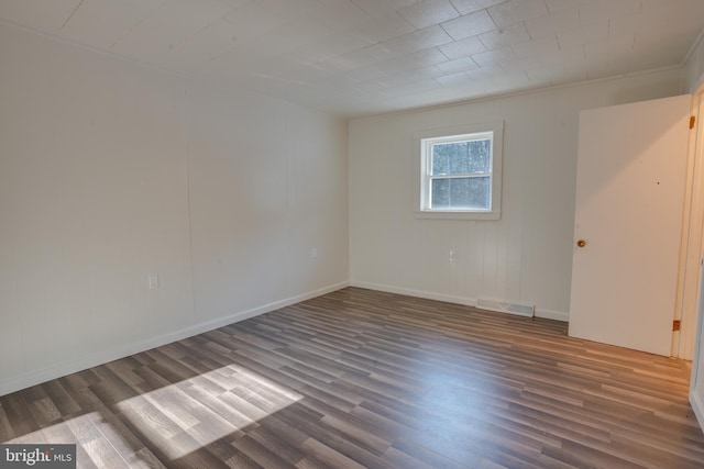 spare room with dark hardwood / wood-style floors