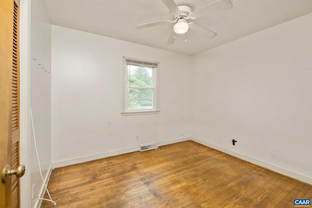 unfurnished bedroom with hardwood / wood-style floors, a closet, a textured ceiling, and ceiling fan