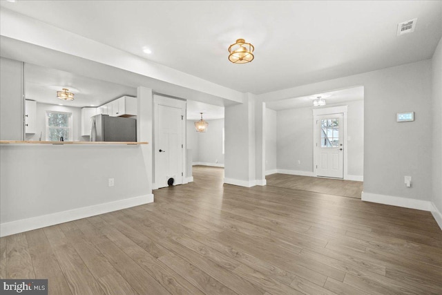 unfurnished living room with hardwood / wood-style flooring