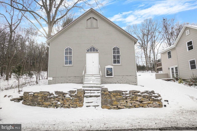 view of snow covered rear of property