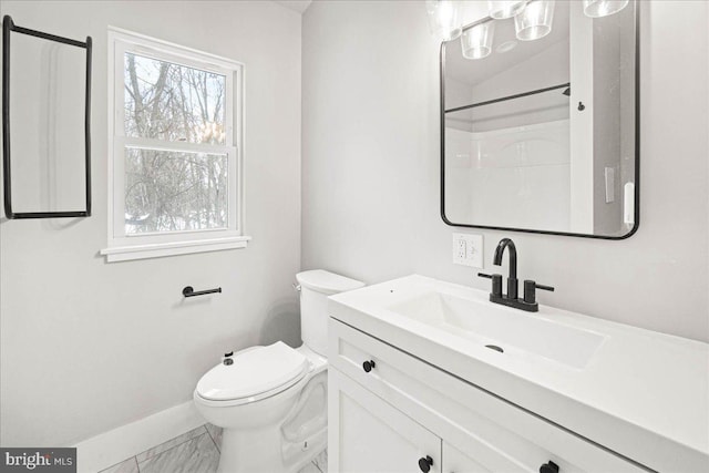 bathroom featuring a shower, vanity, and toilet